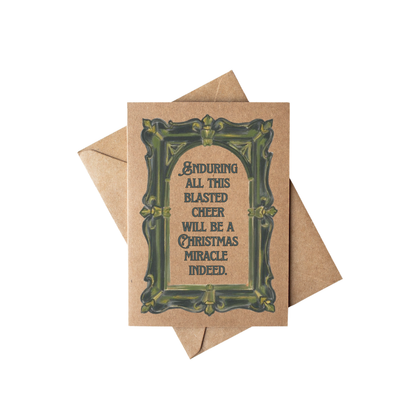 A square kraft paper greeting card with a decorative dark green ornate border and humorous text reading &