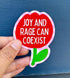 Hand holding a red flower-shaped sticker with &