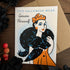A Halloween-themed greeting card featuring a vintage-style illustration of a woman in a black werewolf fur coat and orange dress, with the text &