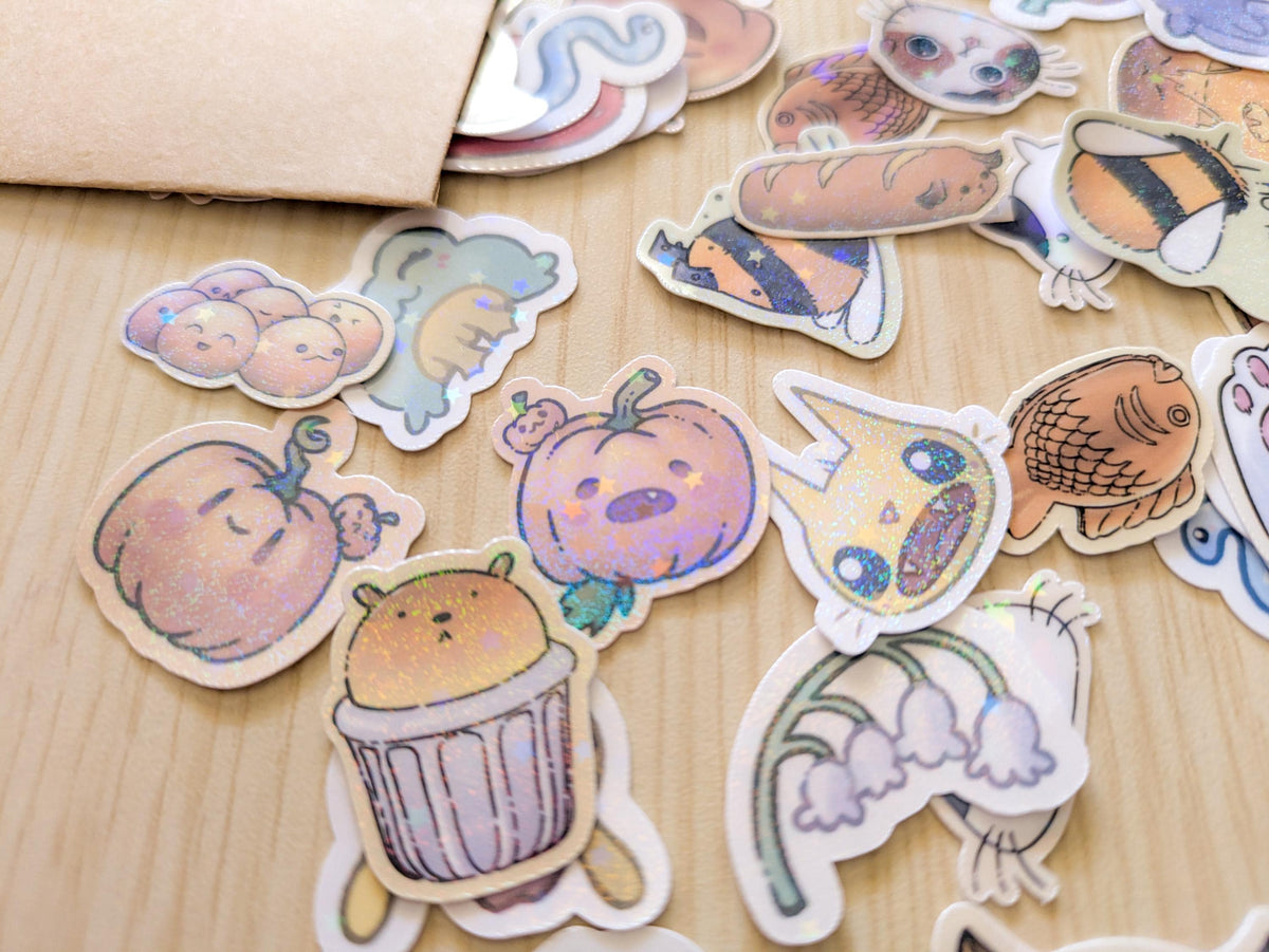Collection of cute, hand-drawn stickers on a wooden surface
