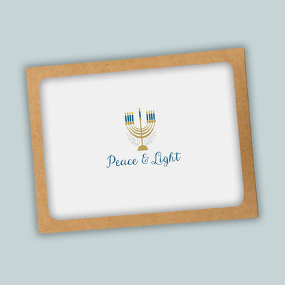 A greeting card with a peace and light theme, featuring a stylized menorah with candles and the text "Peace &amp; Light" on a white background.