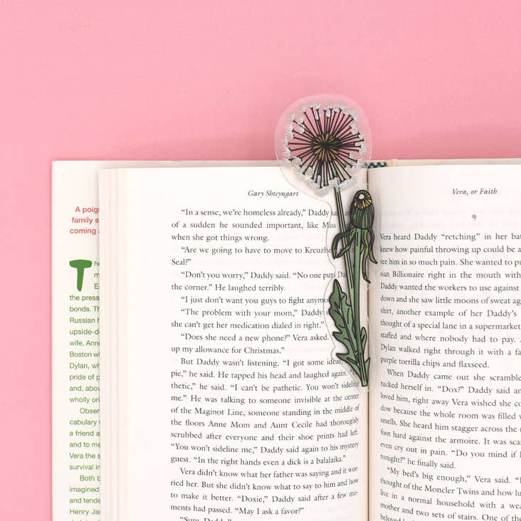 Floral bookmark on an open book with a pink background