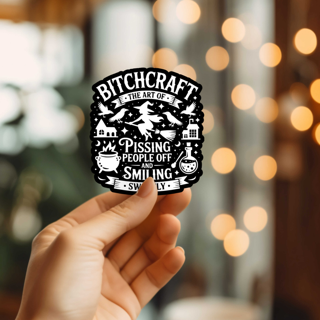 Hand holding a sticker with &