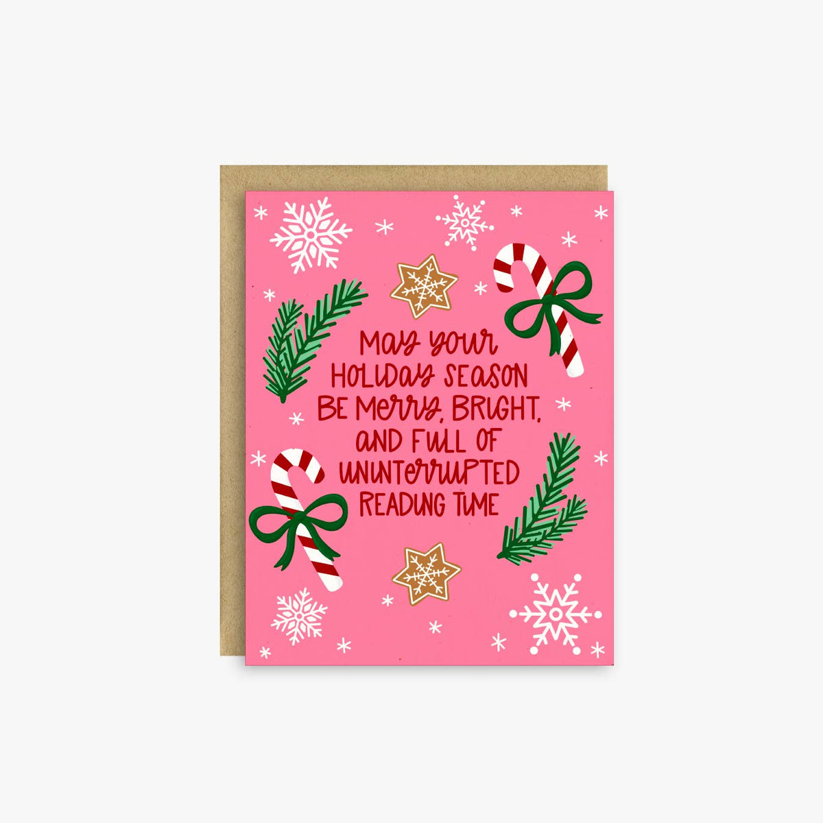 A pink Christmas greeting card with a kraft envelope, featuring holiday illustrations like snowflakes, candy canes, pine branches, bows, and gold stars, with the text &