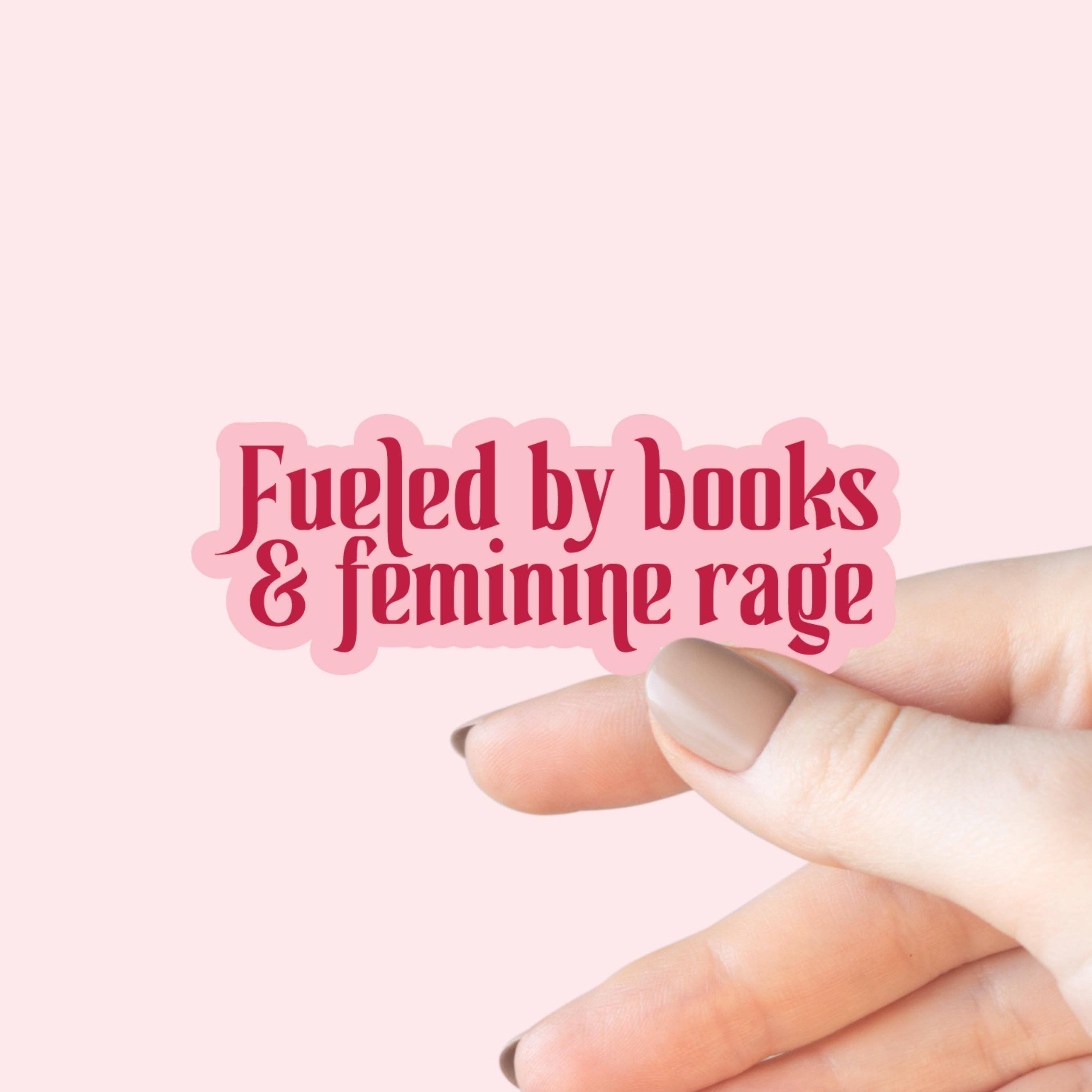 Hand holding a pink sticker with &