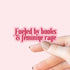 Hand holding a pink sticker with &