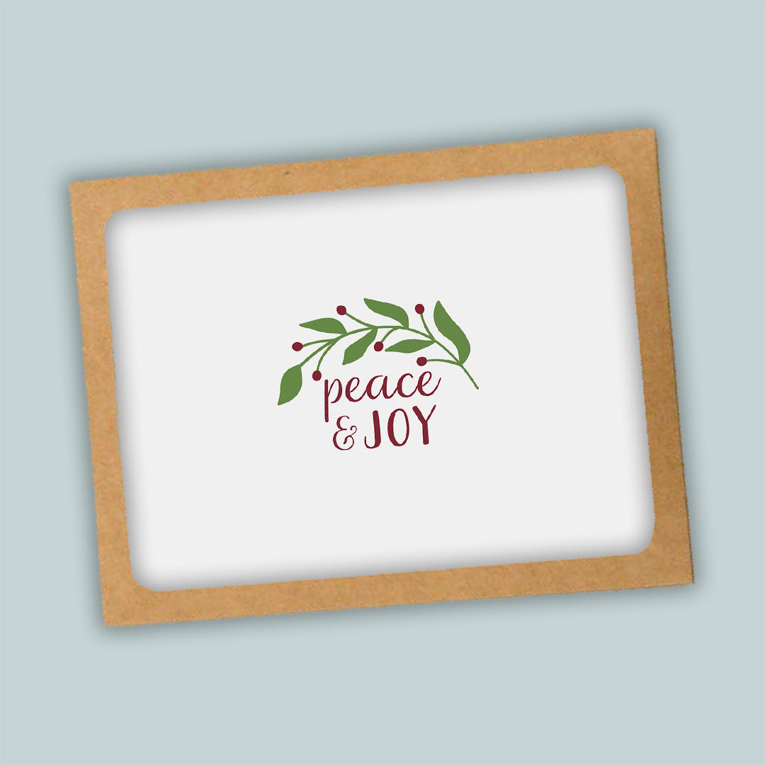 A white background with a brown frame containing a decorative wreath and the text "Peace &amp; Joy" in a cursive font.
