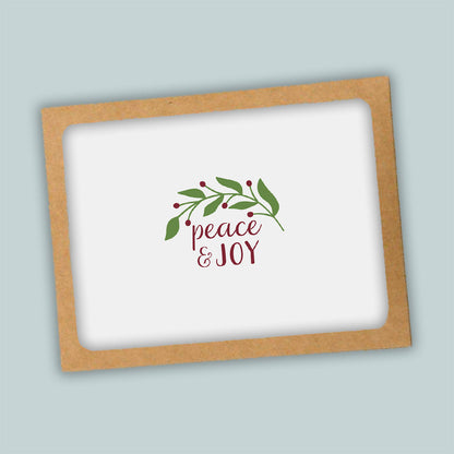 A white background with a brown frame containing a decorative wreath and the text "Peace &amp; Joy" in a cursive font.