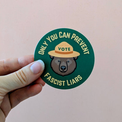 Sticker with bear wearing a hat and text on a pink background