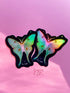 Two butterfly-shaped stickers with iridescent pastel wings on a black starry background, displayed on a pink surface with the text &