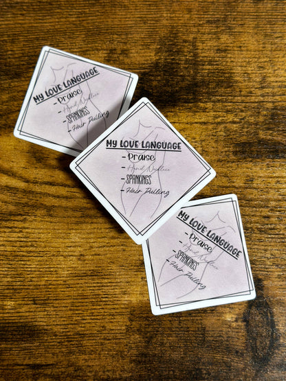 Three playing cards with text on a wooden surface
