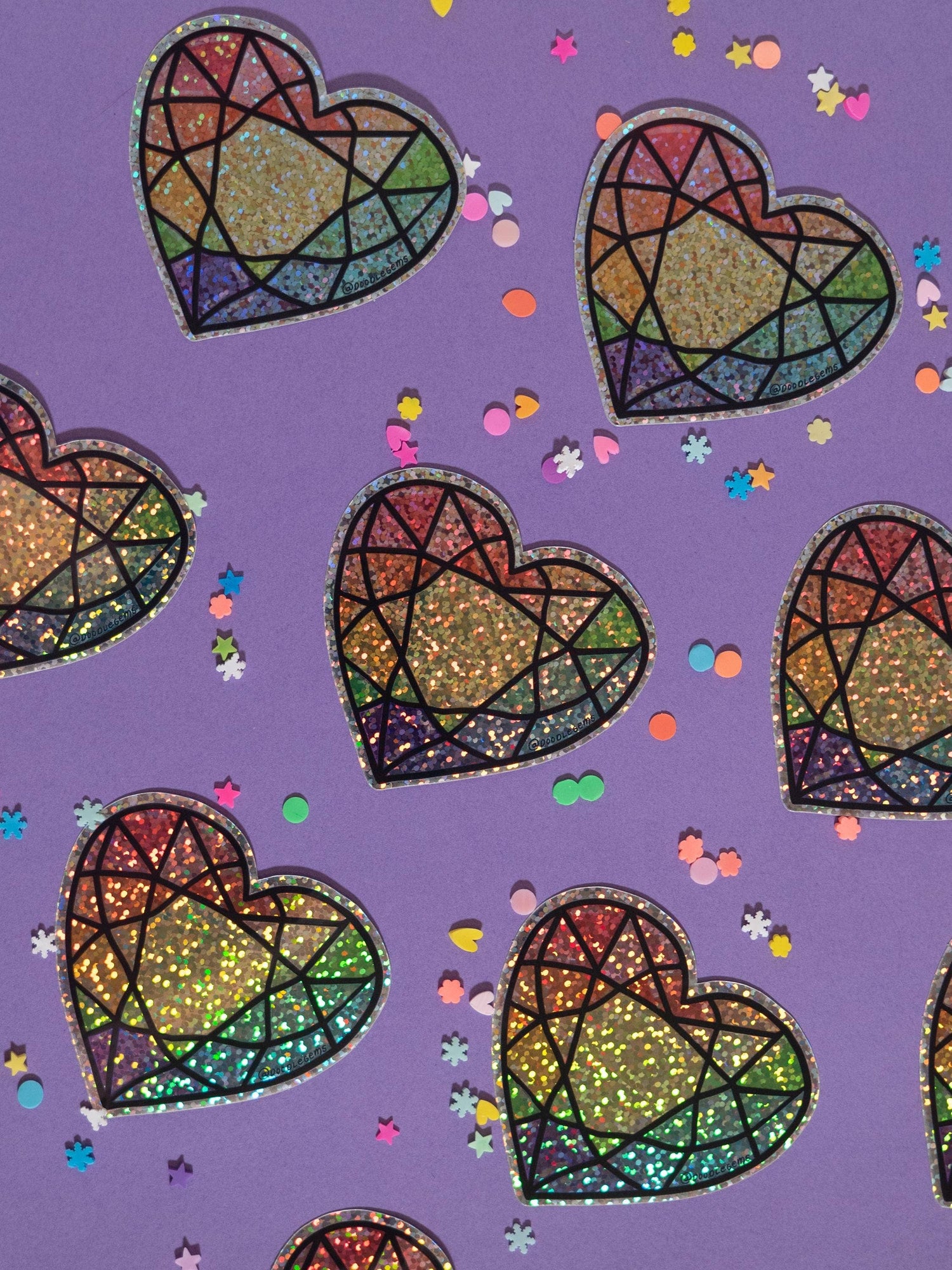 Colorful heart-shaped stained glass patterns on a purple background with confetti.