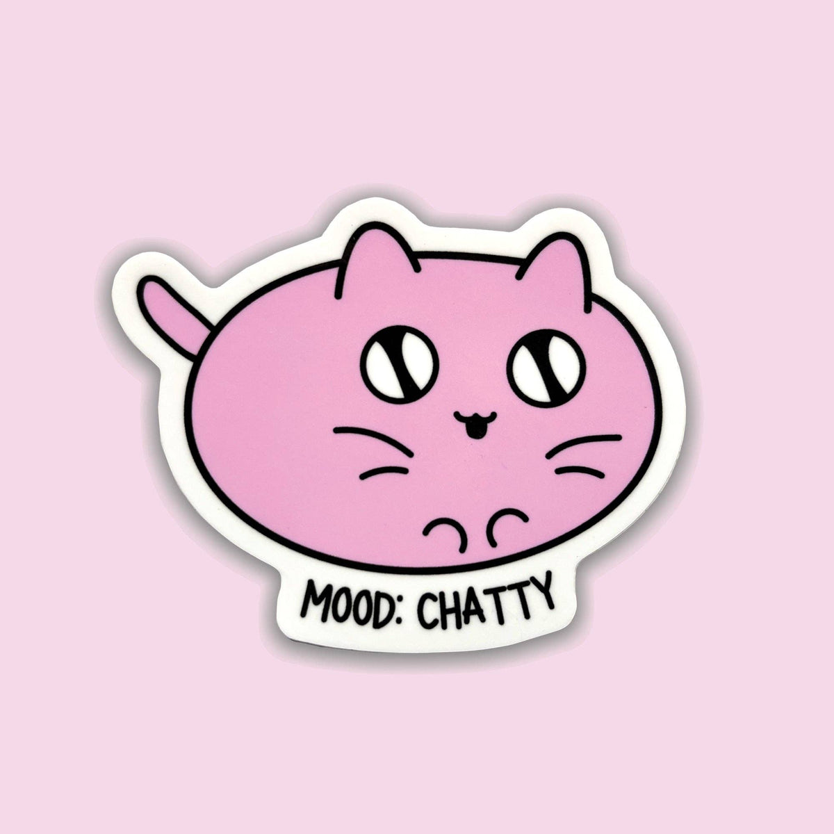 A die-cut sticker featuring a pink cartoon cat face with the text &