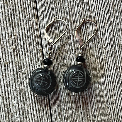 Fortune Stone Earrings featuring carved red jasper and black onyx, symbolizing luck and style.