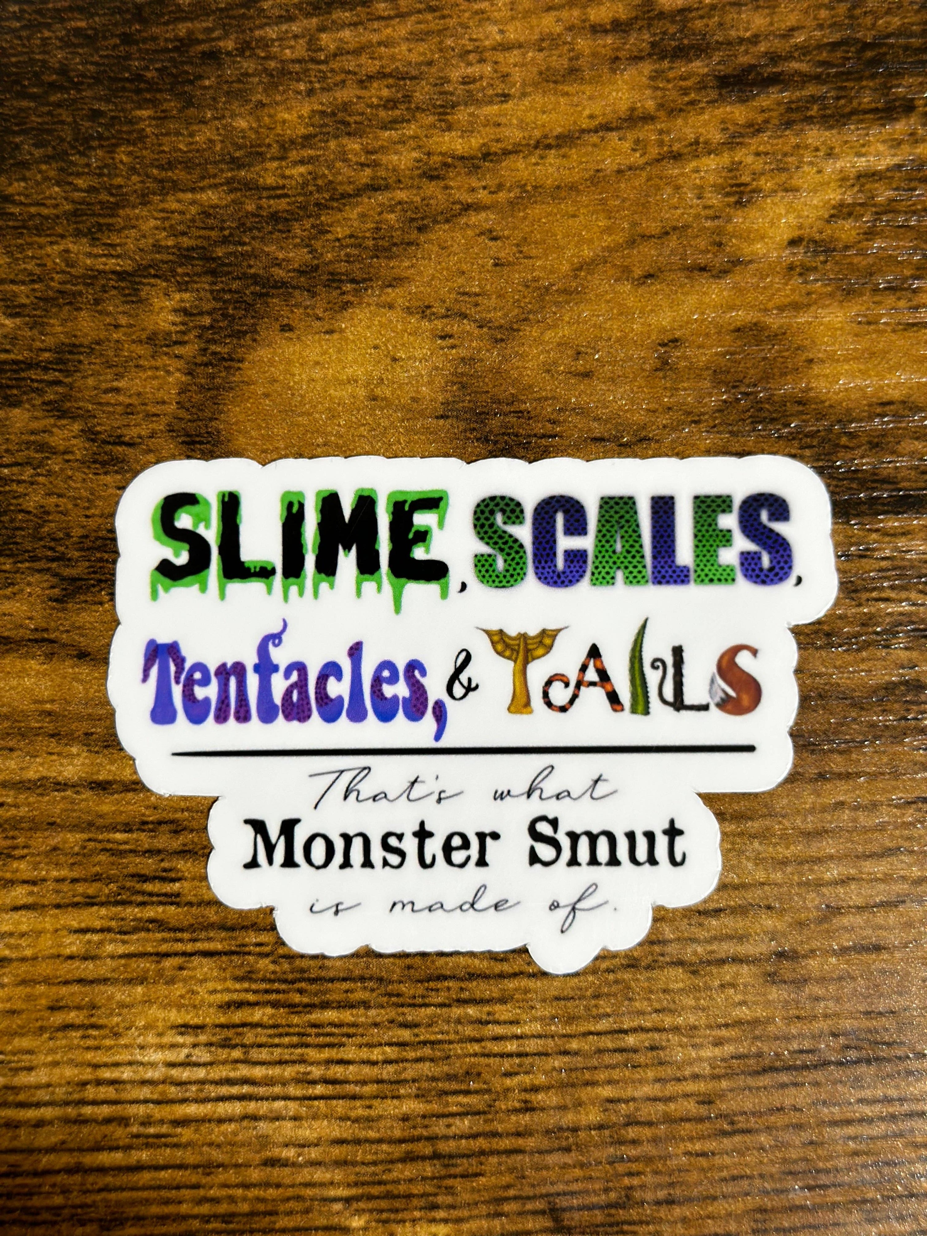 Sticker with colorful text on a wooden surface