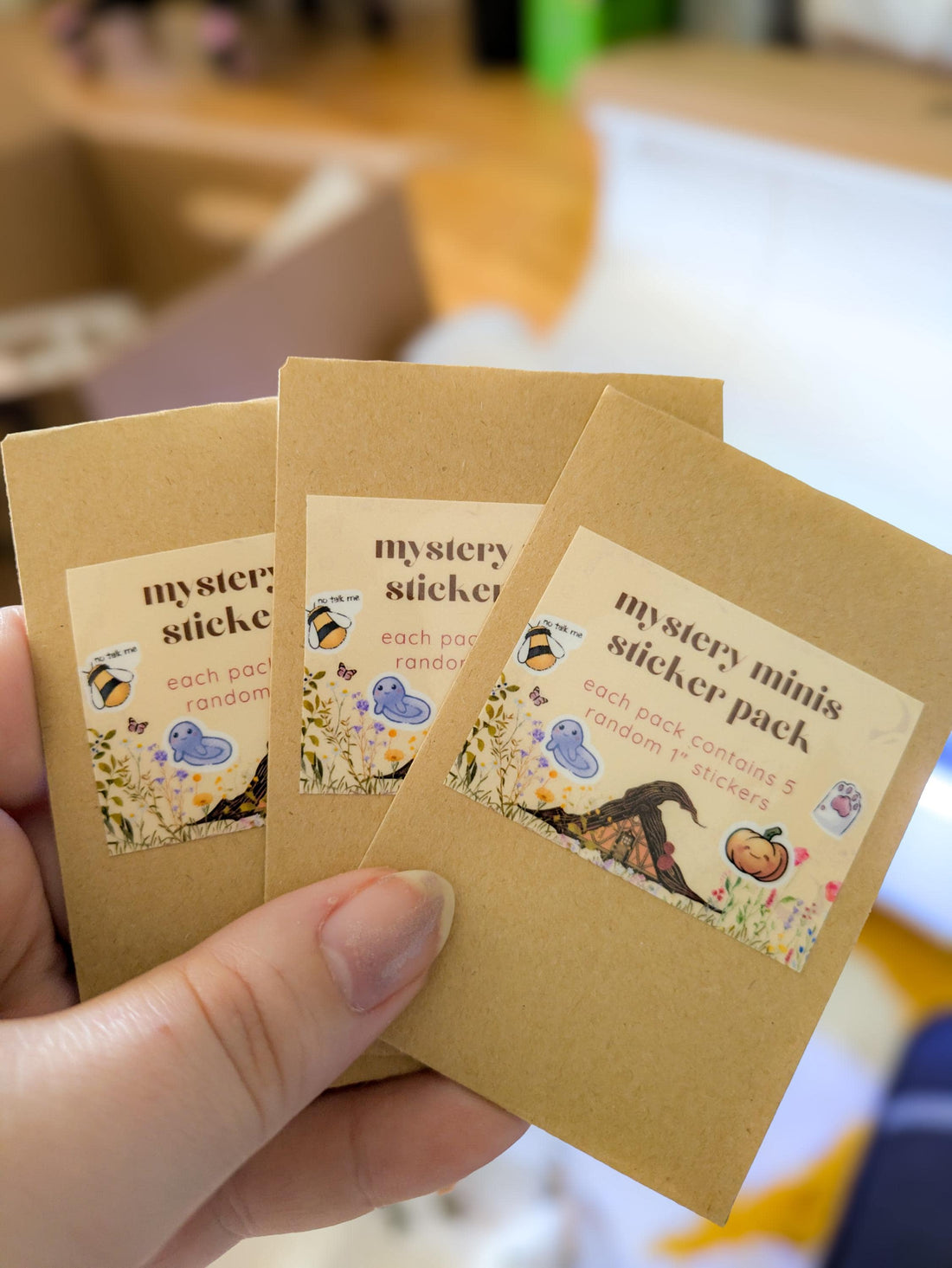 Three small brown paper packages labeled &