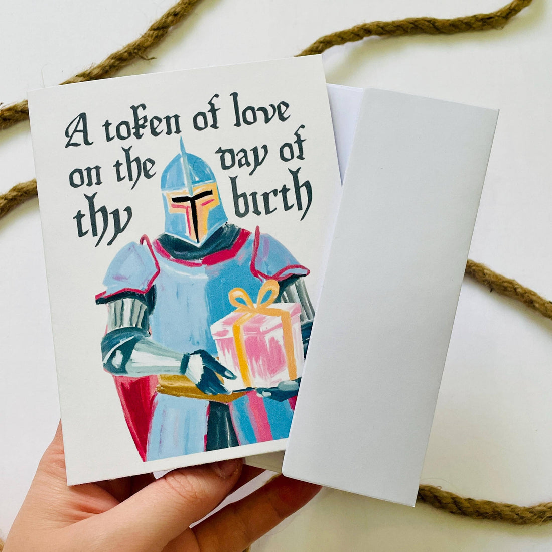 Card with a character holding a gift and text &