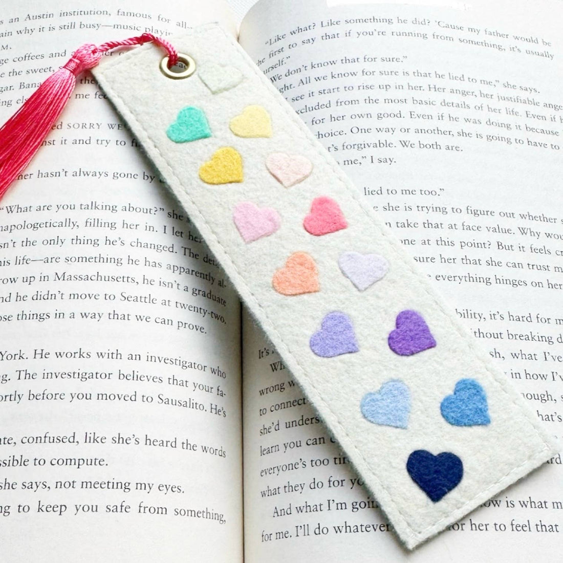 Bookmark with heart-shaped decorations on a book page