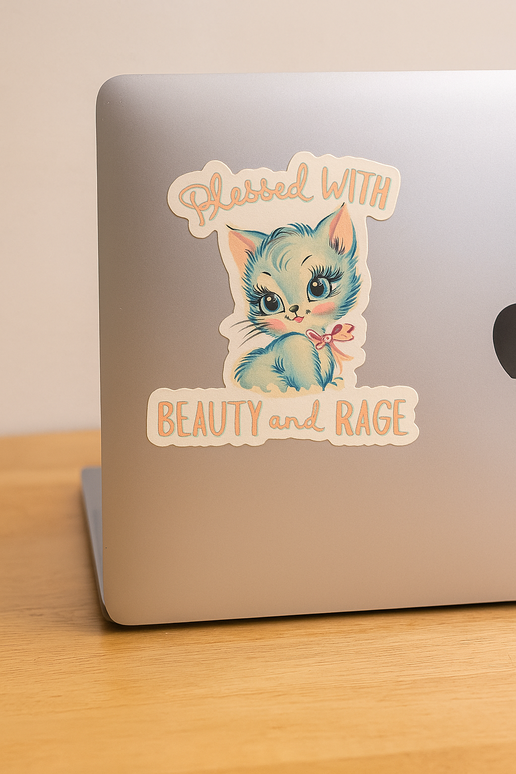 Laptop with a sticker of a cat with text &