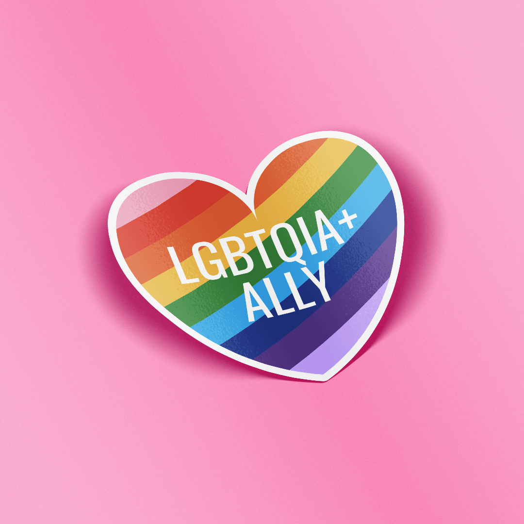 A heart-shaped sticker with a rainbow stripe pattern and the text &