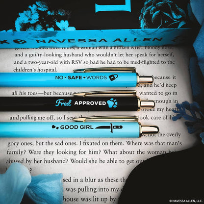 Three pens with text labels on a book page, featuring the brand &