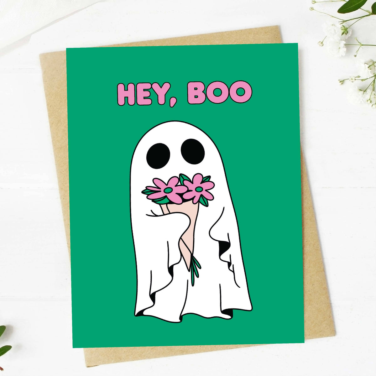 Greeting card with a ghost holding flowers and &