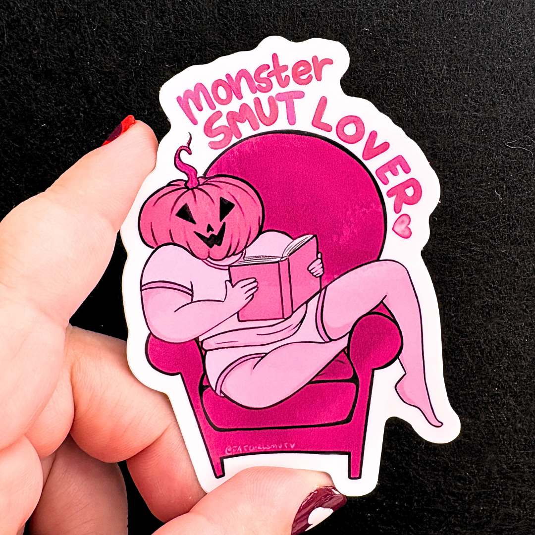Sticker with a pink pumpkin character reading a book and &