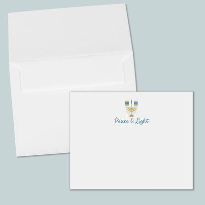 an open white envelope with a printed "Peace &amp; Light" logo on the front.