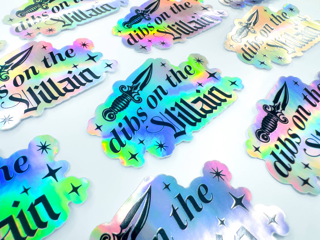 Holographic stickers with text and designs on a white background