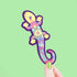 Colorful lizard-shaped bookmark held against a green background
