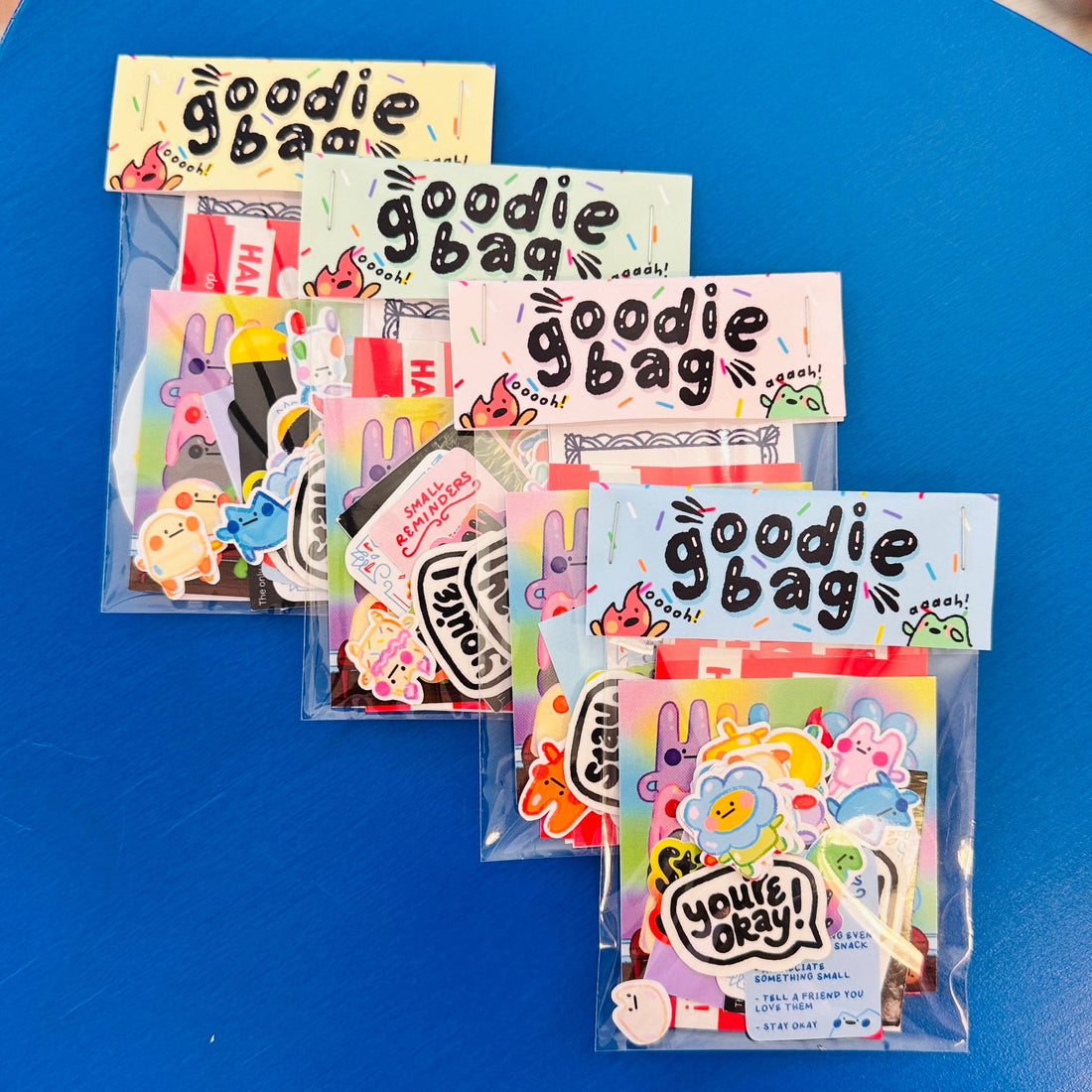 Goodie bag packaging with colorful designs on a blue surface