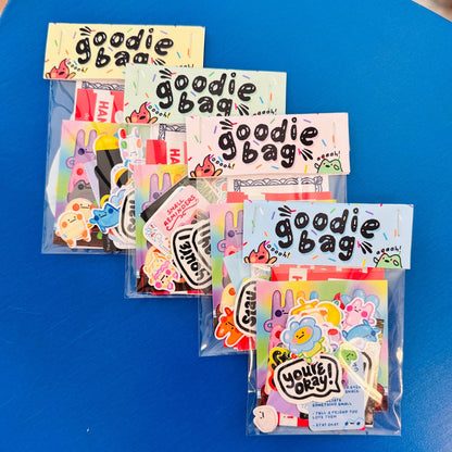 Goodie bag packaging with colorful designs on a blue surface