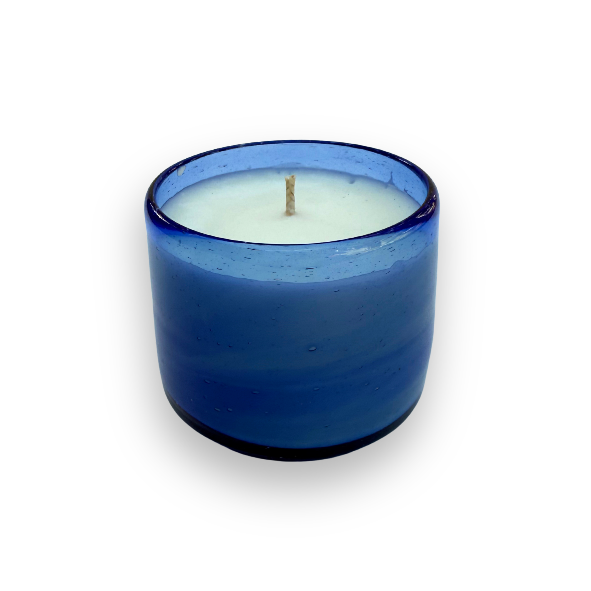 Blue glass candle with a white candle inside on a white background