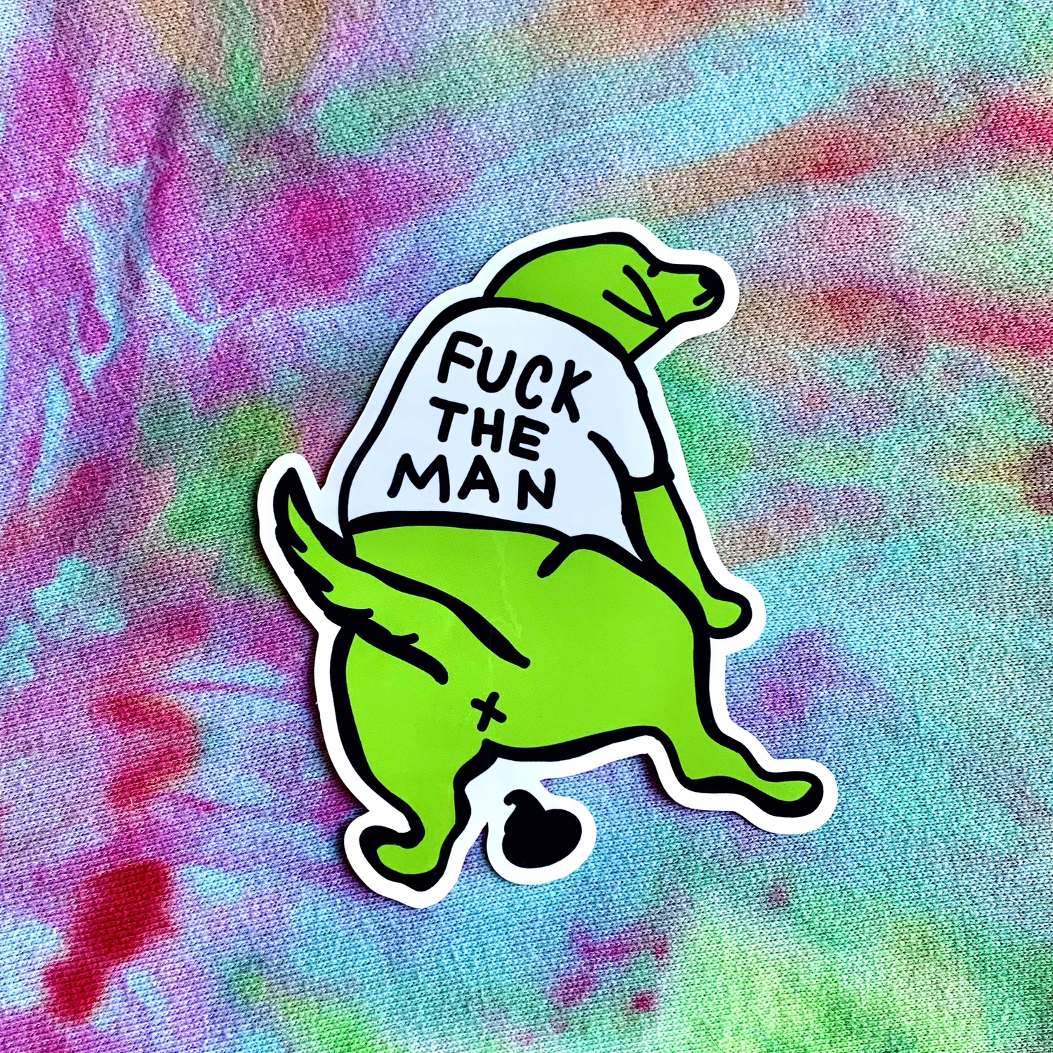 Green cartoon character with a shirt reading &