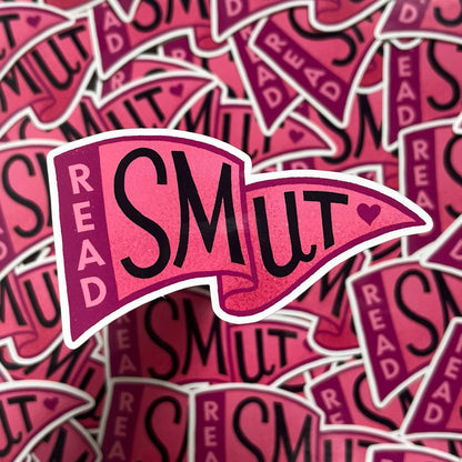 A close-up pile of die-cut stickers featuring the phrase &