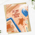A square greeting card with a gingerbread-themed illustration and the text &