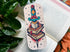 Colorful tattoo-style bookmark on an open book with a plant in the background