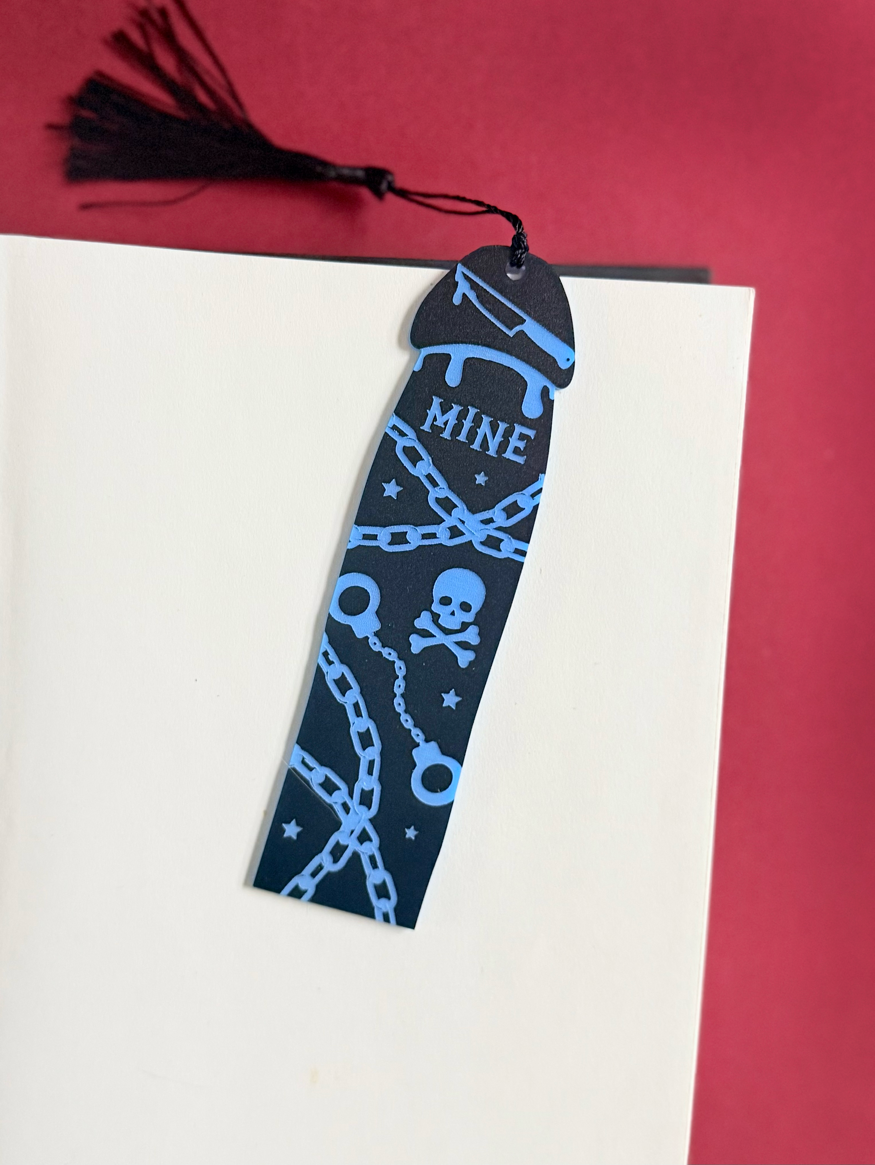 Black bookmark with blue designs and &