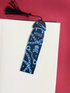 Black bookmark with blue designs and &