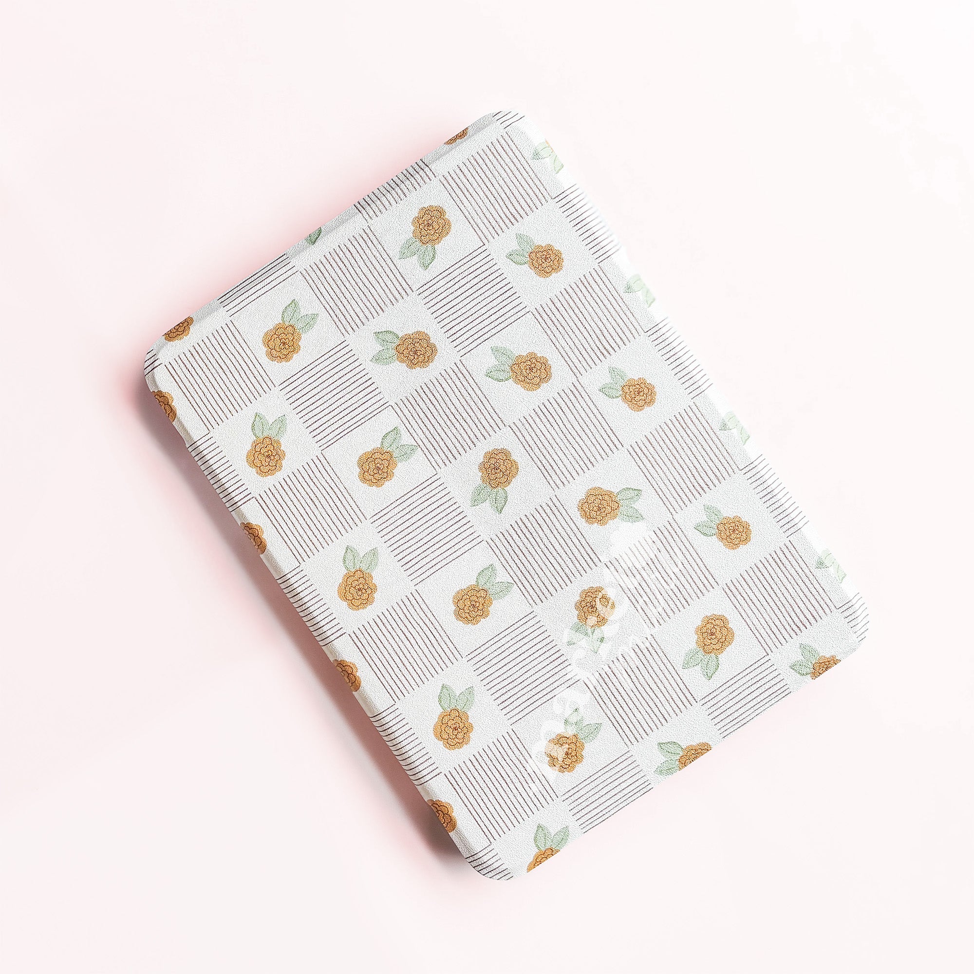 a square-shaped object with a repeating pattern of orange flowers and green leaves on a white background.