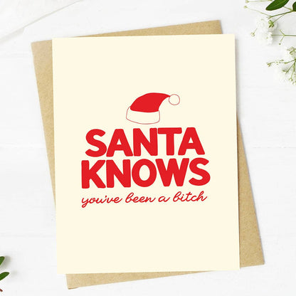 A Christmas greeting card with a kraft envelope, featuring the text &