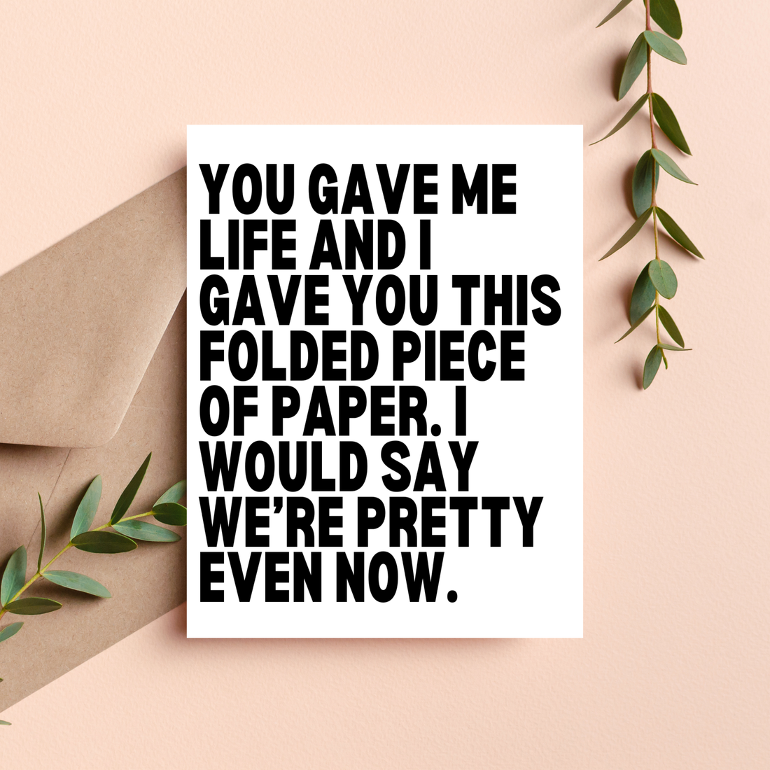 Card with humorous text on a beige background with greenery