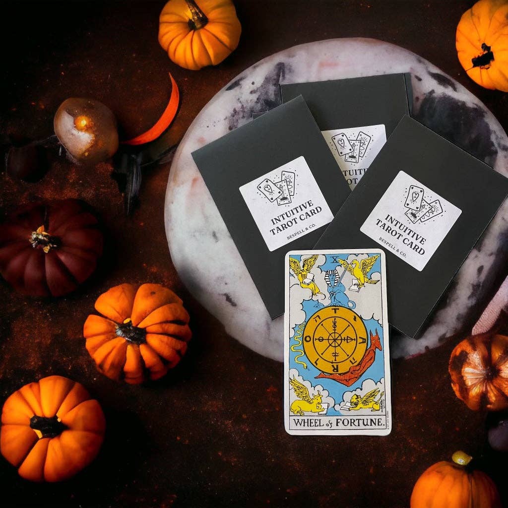 Tarot cards with pumpkins and a full moon on a dark surface