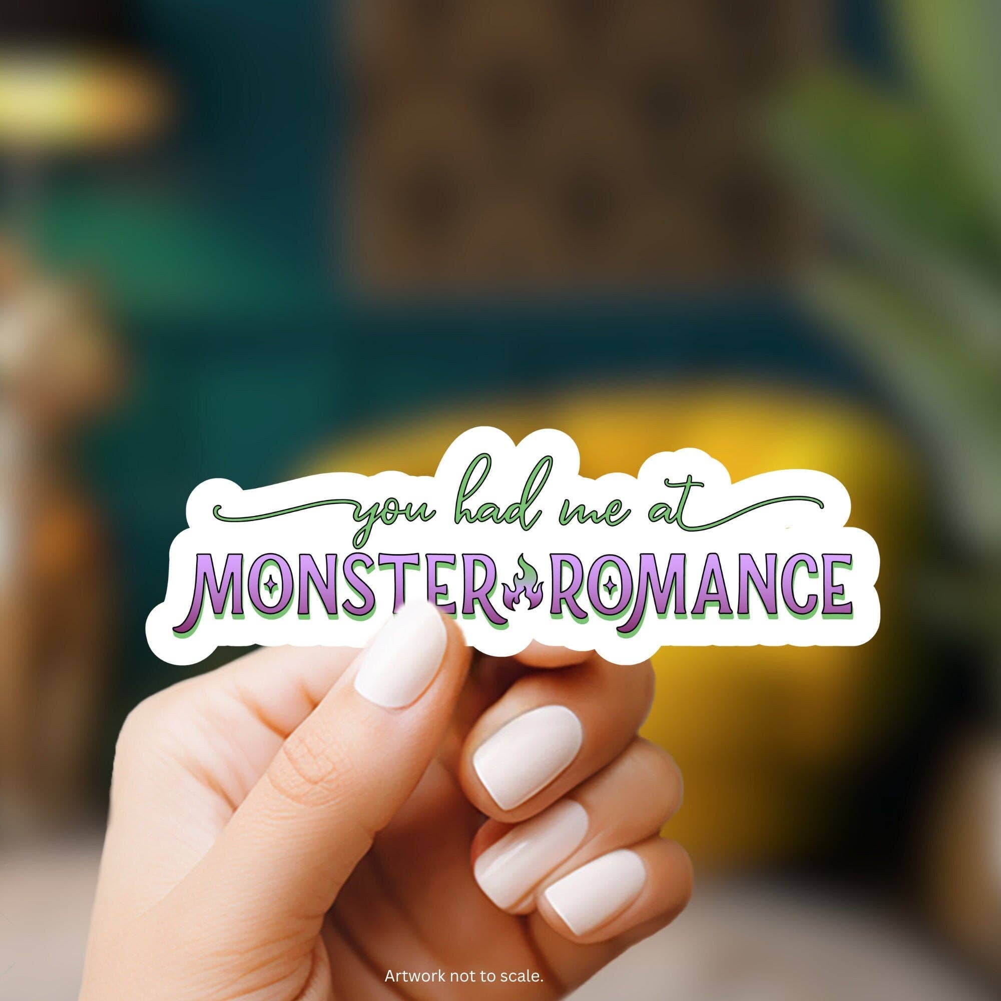 Hand holding a sticker with &
