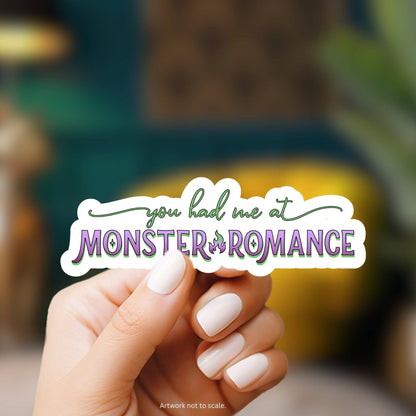 Hand holding a sticker with &