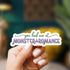Hand holding a sticker with &