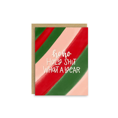A greeting card with a kraft paper envelope, featuring diagonal stripes in red, green, and pale pink with the text &