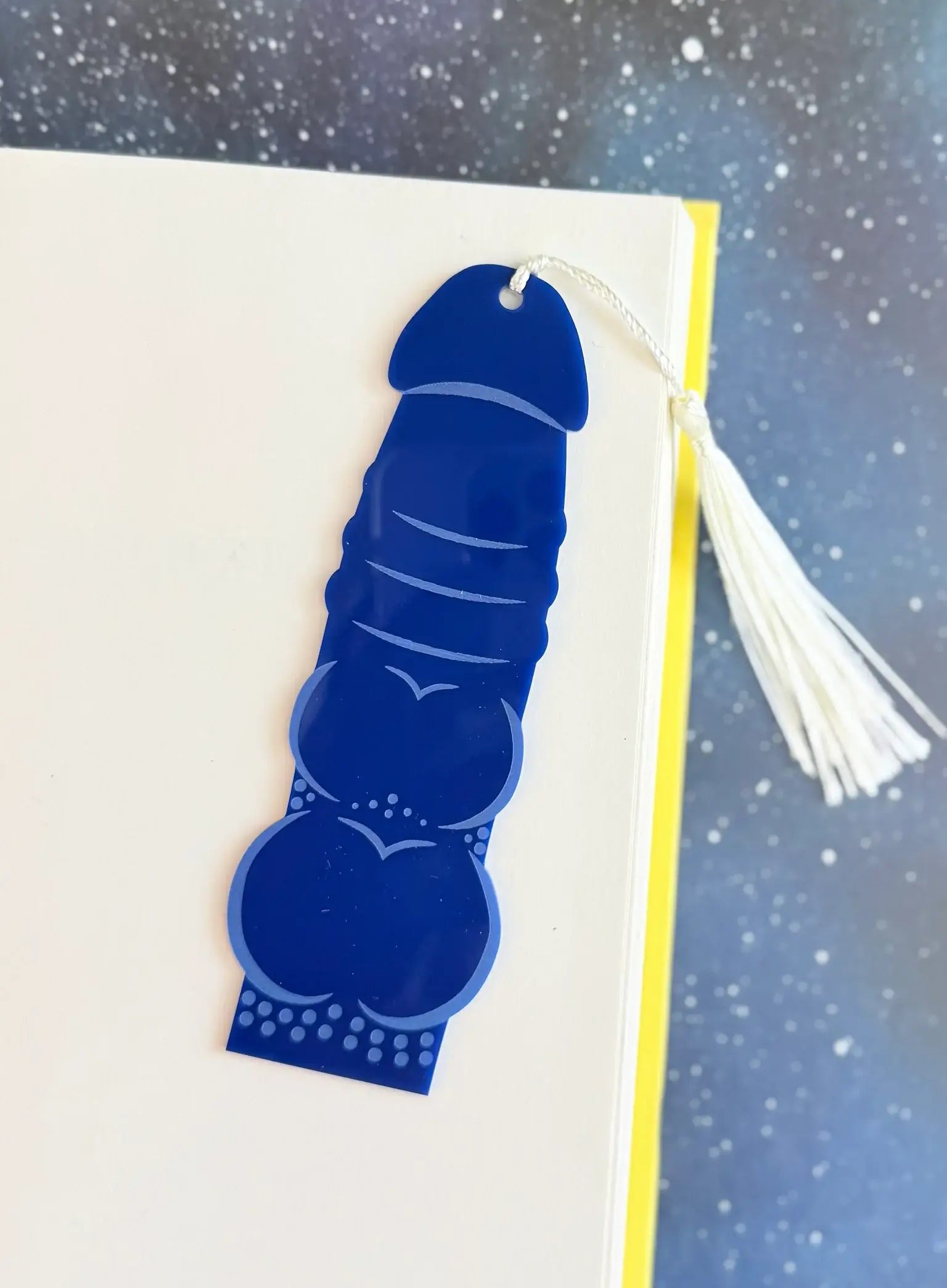 Blue decorative bookmark with tassel on a white background
