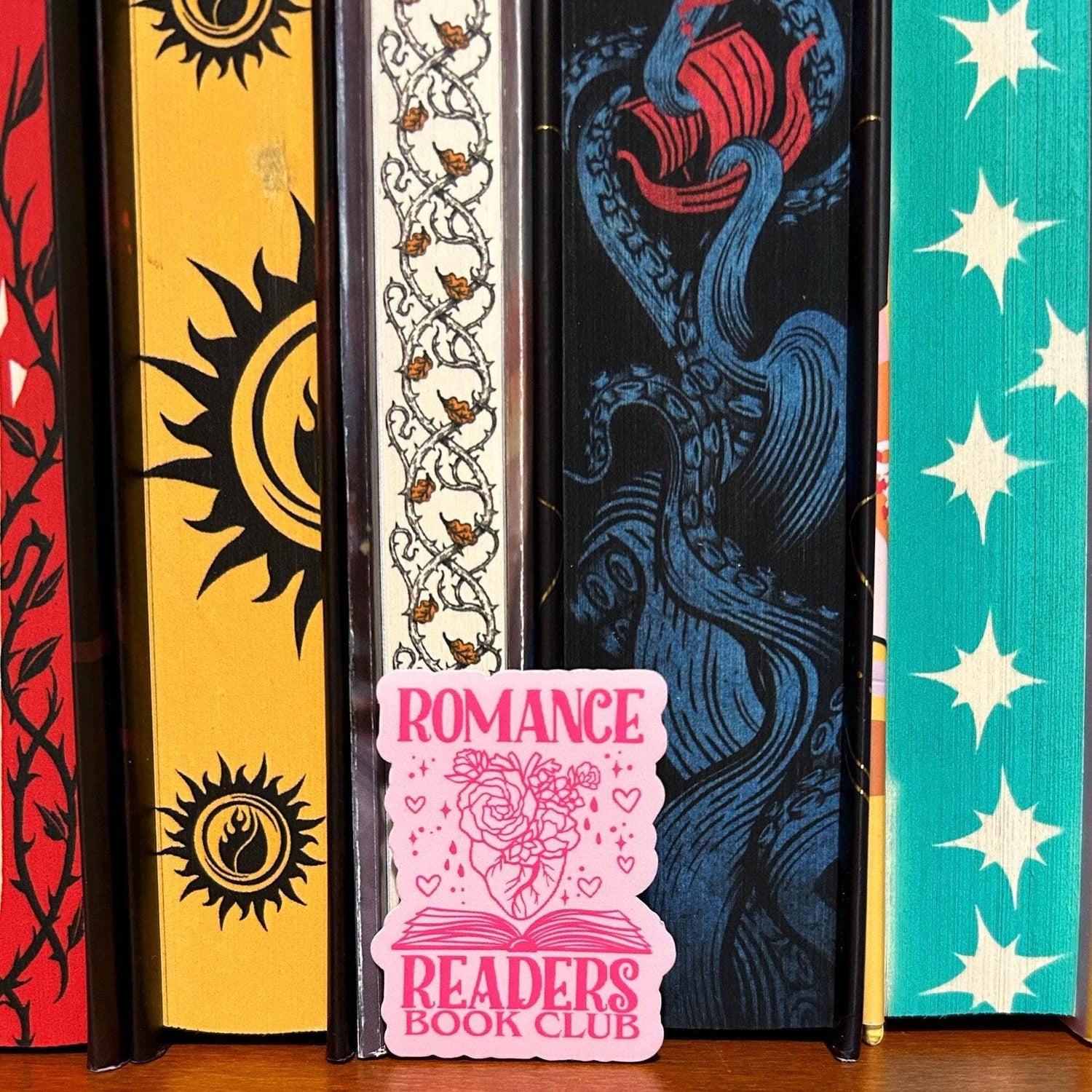 Colorful book spines with decorative designs and a &