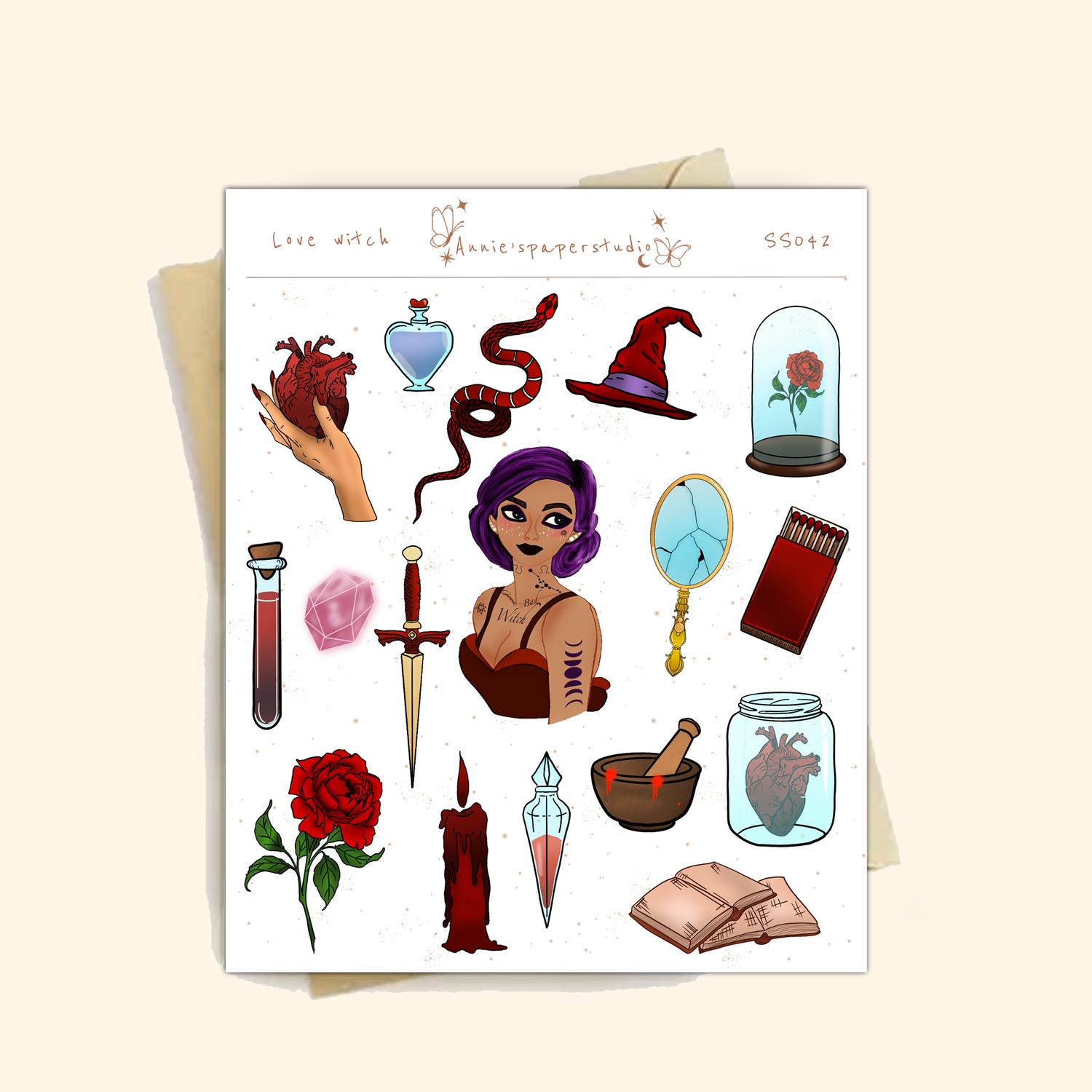 A sheet of gothic-themed microglitter stickers displayed on a light beige background. The sheet features various illustrations such as a purple-haired witch, a red rose under a glass cloche, a dagger, a potion bottle, a snake, and a red candle, with the text &